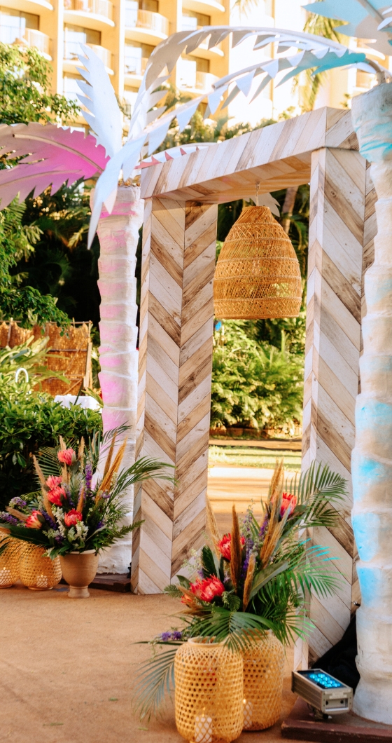 Tropical ceremony under palm trees, decorated with vibrant flowers, creating a romantic and festive atmosphere.