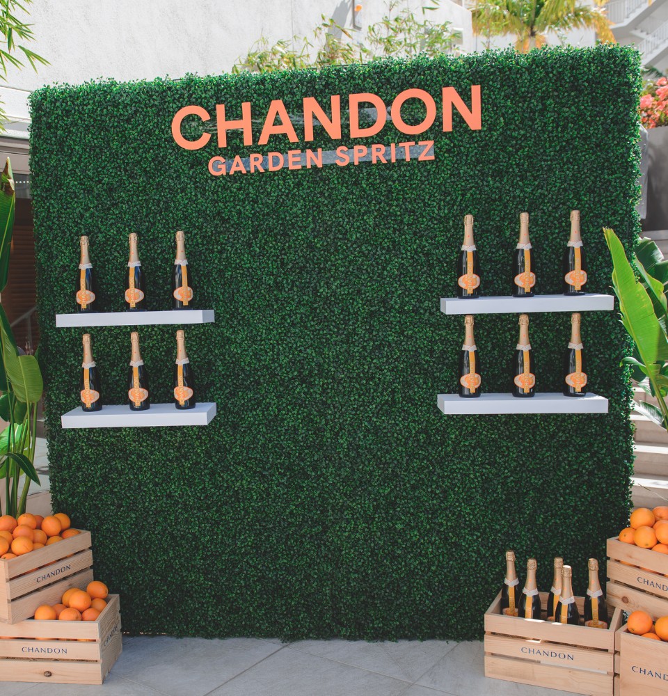 Chandon Garden Sprouts event showcasing vibrant greenery and lively atmosphere with guests enjoying the outdoor setting.