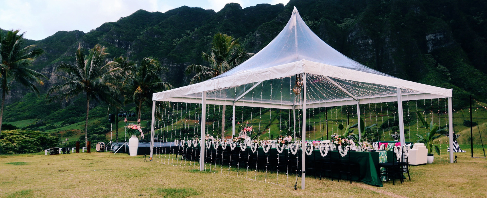 A tent that is beautifully arranged on a grassy field, ready for a special celebration.