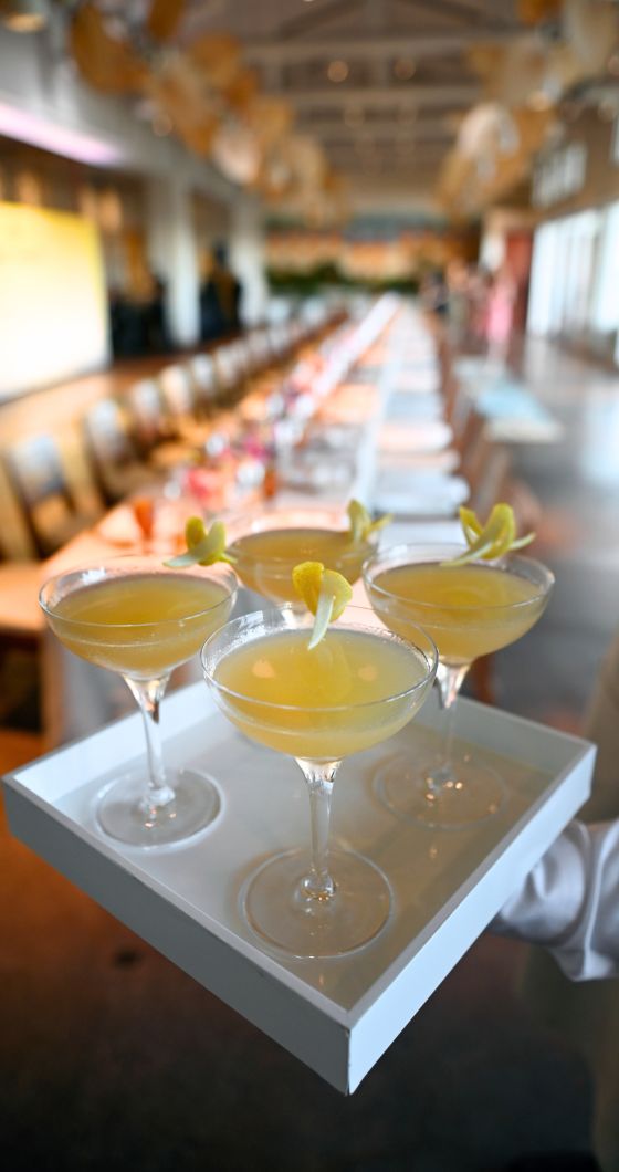 A tray with four refreshing glasses of lemonade, each filled to the brim and garnished with lemon slices.