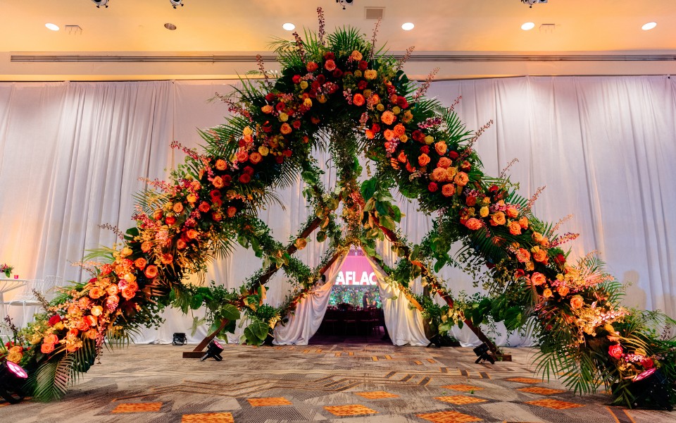 A beautiful ceremony featuring a large floral arch, creating a romantic and vibrant atmosphere.