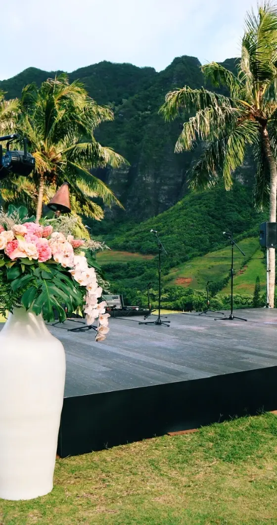 A black stage set up in front of the Koolau mountains in Hawaii