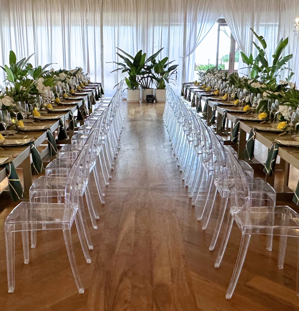 Two long tables set with chairs, ready for a large celebration meal.